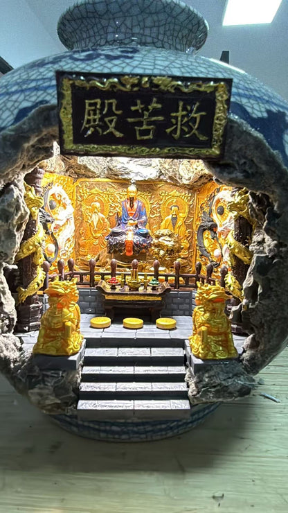 Close-up interior view of the 救苦殿 miniature shrine diorama featuring Tai Yi Zhen Ren on a throne flanked by other Zhen Ren figures on carved golden panels, with two gold Kirin pillars and three cushions around the altar steps
