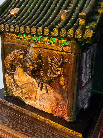 Back view of a car shrine temple model with Tua Di Ya Pek embossed in black, white, and gold on the rear wall